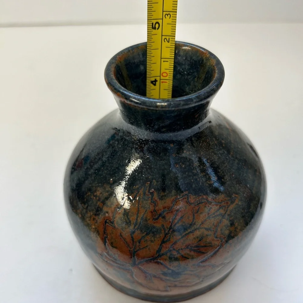 Handmade art pottery vase with a glossy glaze blend of blue and brown/ signed